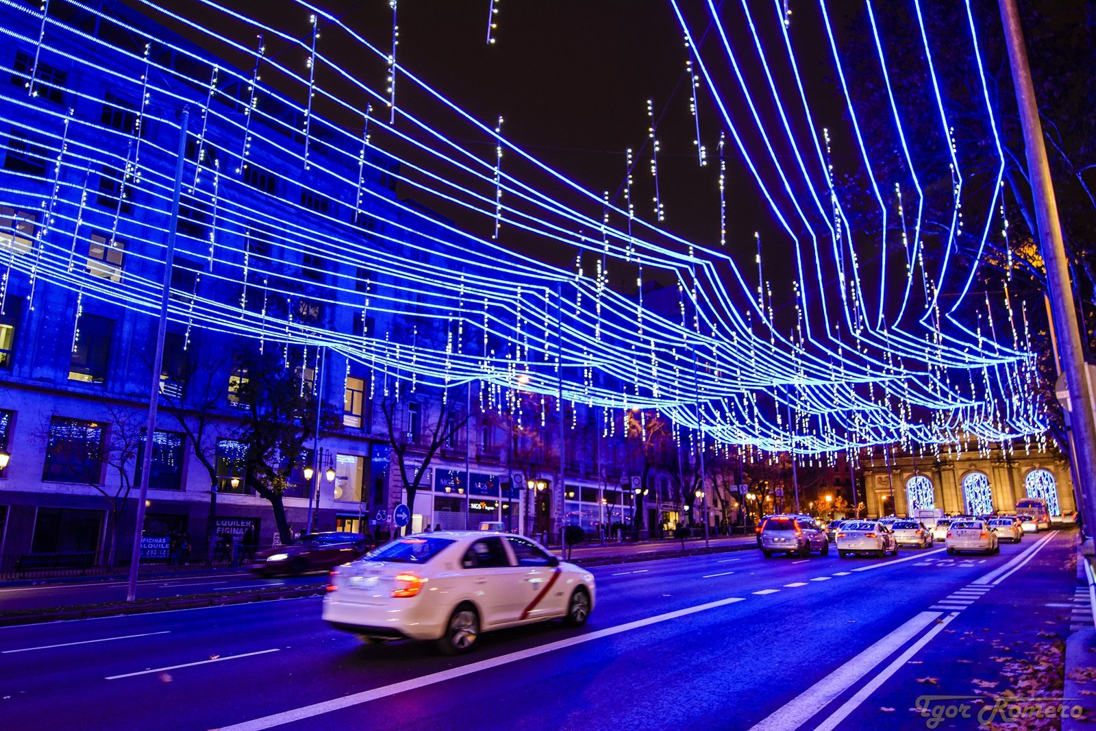 Calle de Alcalá in Madrid with Christmas light arches and the Puerta de Alcalá in the distance