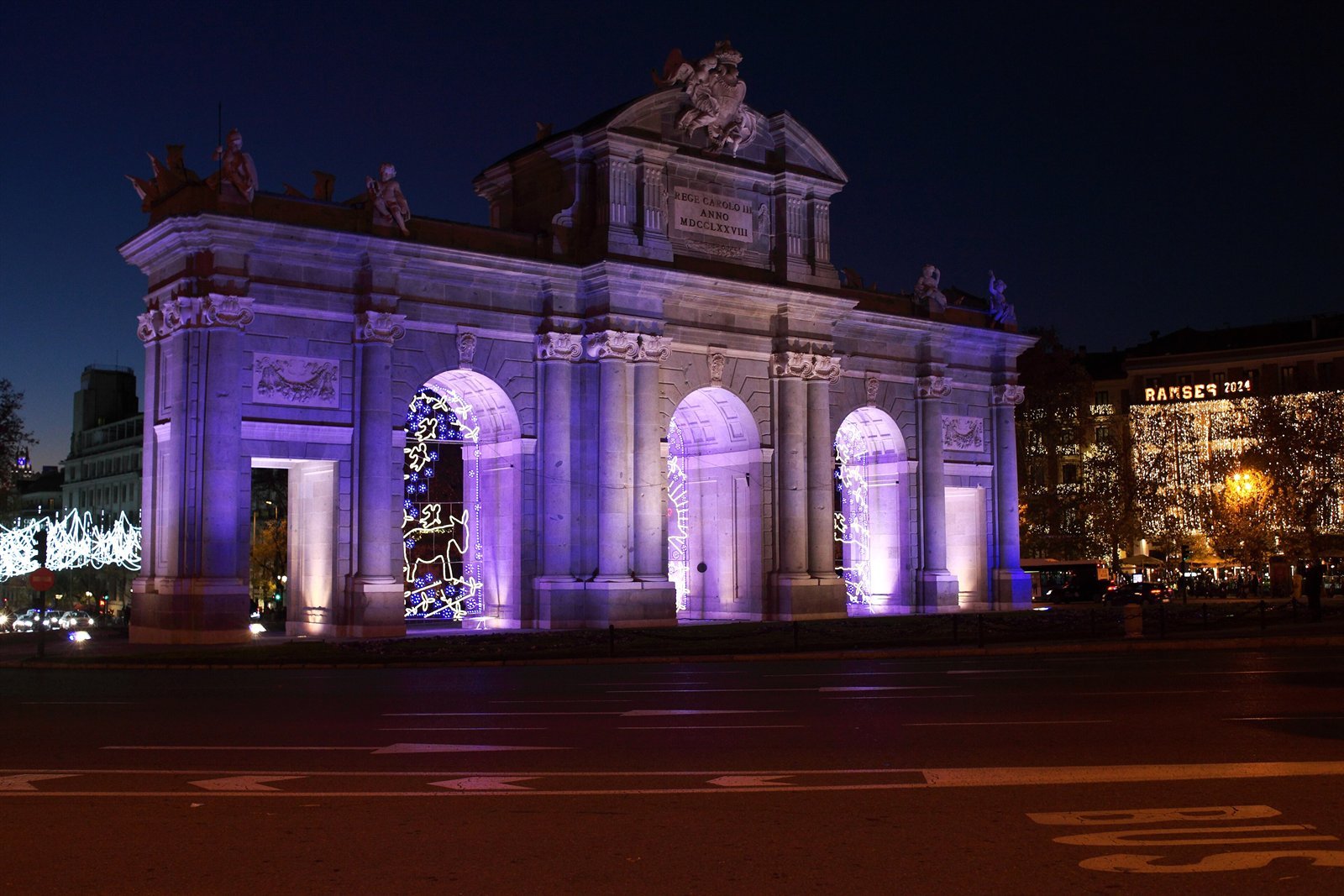 The Puerta de Alcalá in Madrid lit up at night at Christmas